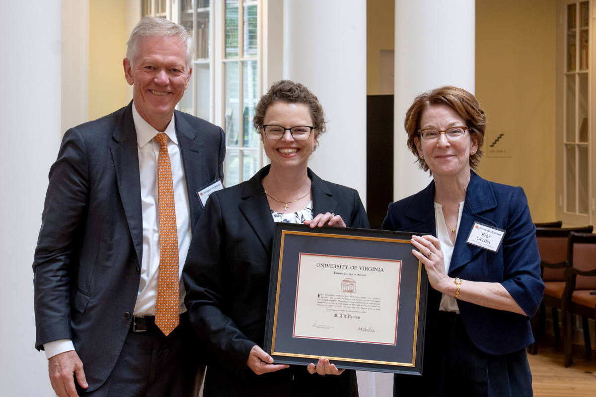 Jill Venton, center, displays her award, flanked by UVA President Scott Beardsley, left, and interim Provost Brie Gertler, right 