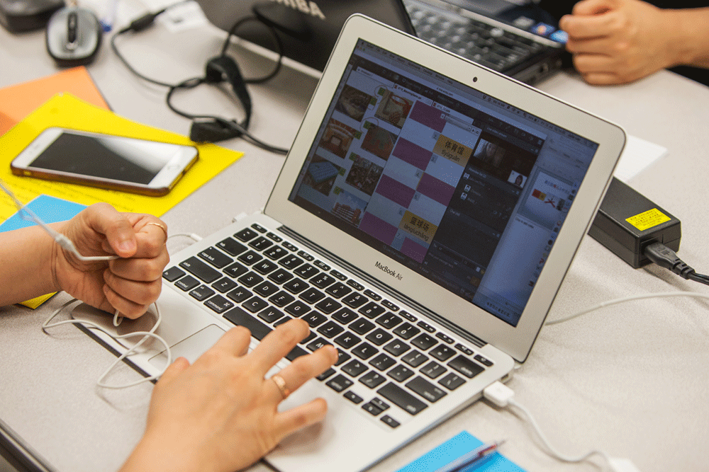 An open laptop with hands resting on keyboard.